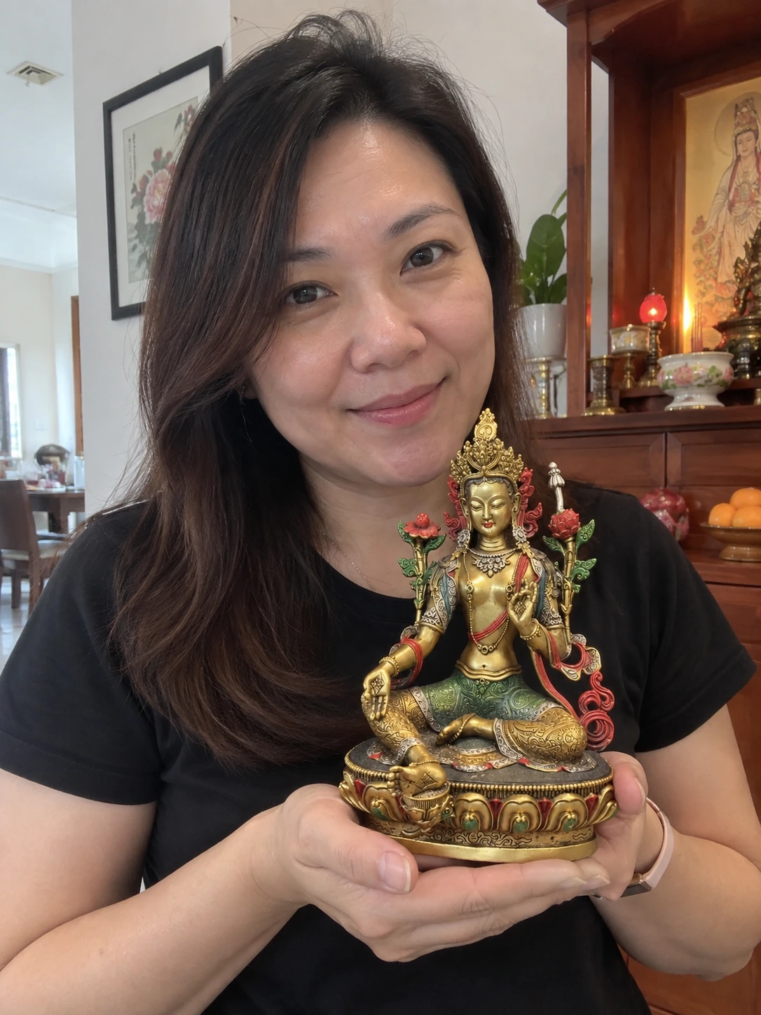 Green Tara statue held in a Malaysian home