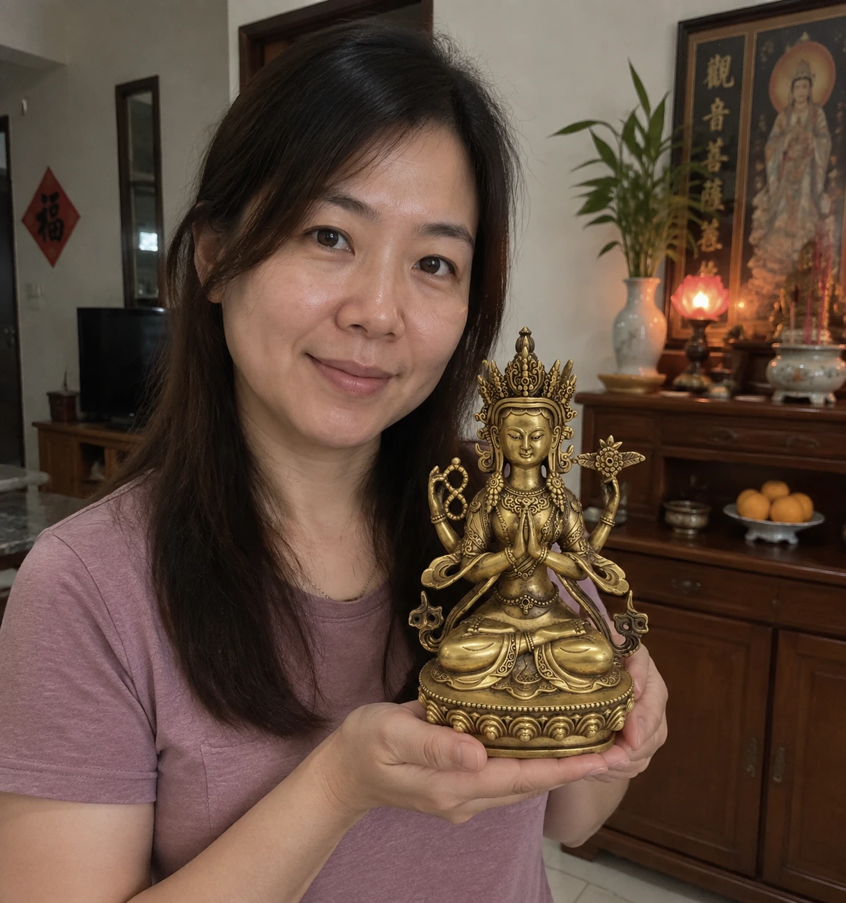 Four-Armed Avalokiteshvara Copper Statue – Compassion and Protection 22 cm held in a Malaysian home