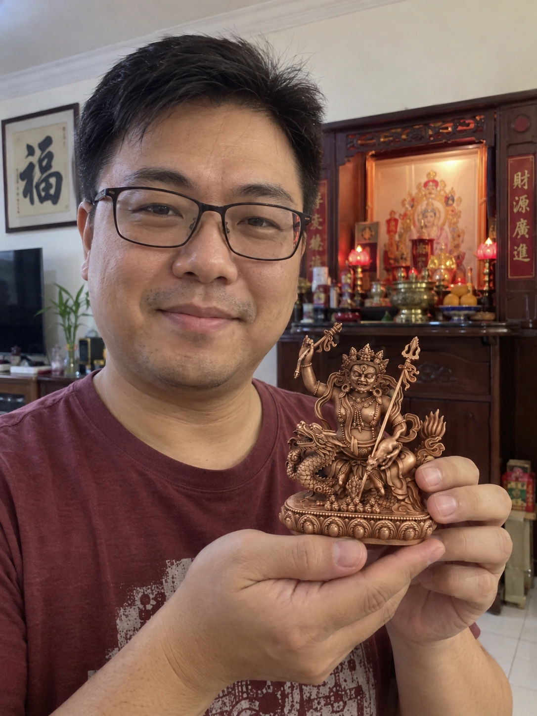 White Jambhala Red Copper Statue – Wealth and Abundance 11 cm held in a Malaysian home