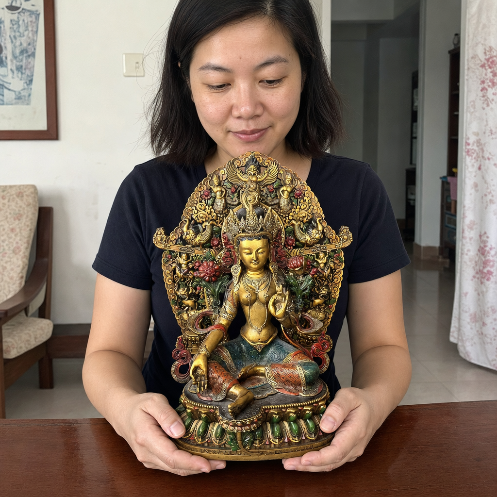 Green Tara statue shown with a person in a home setting